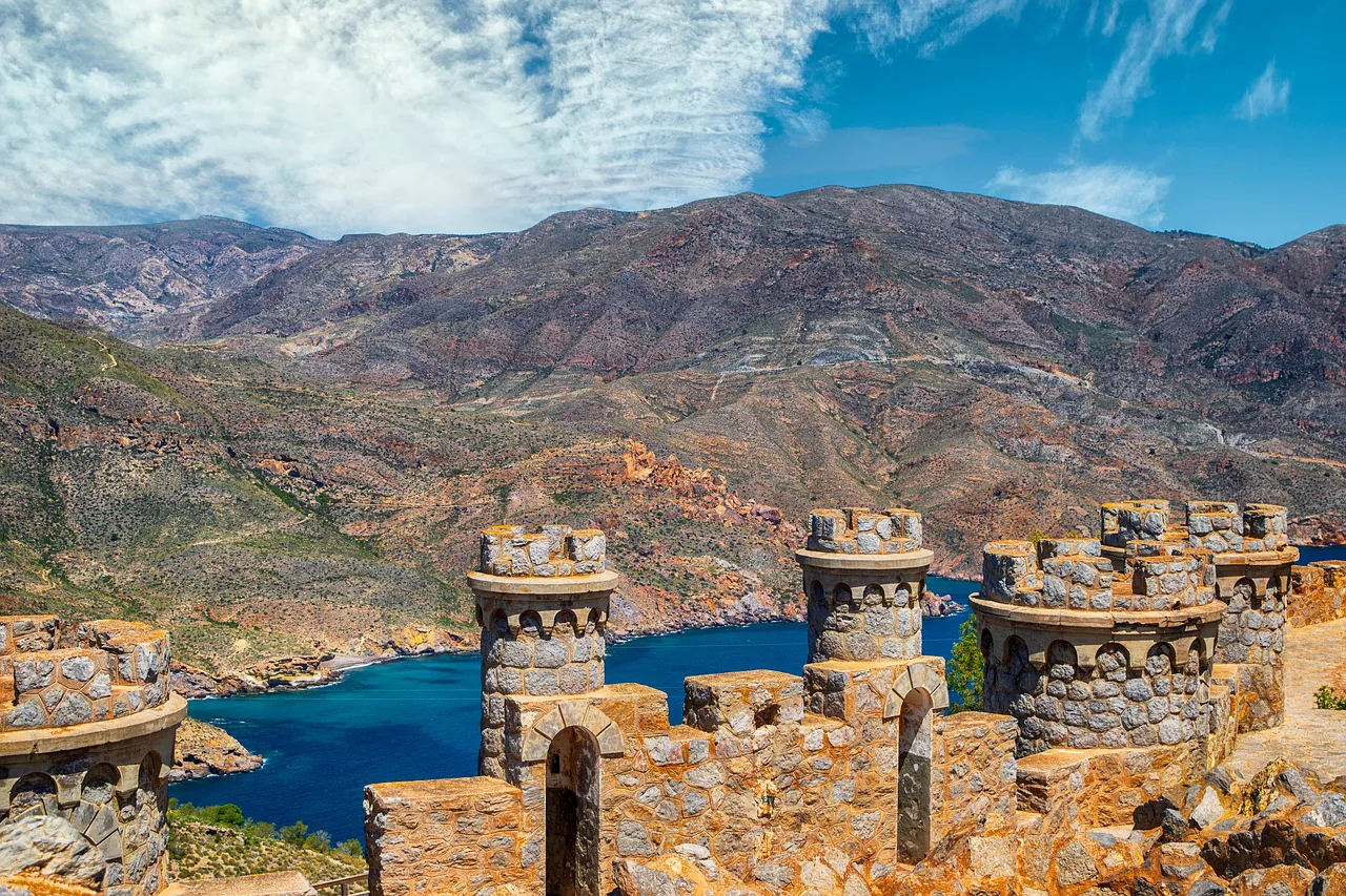 Las torres con forma de castillo de la Batería de Castillitos sobre el mar azul intenso cerca de Cartagena